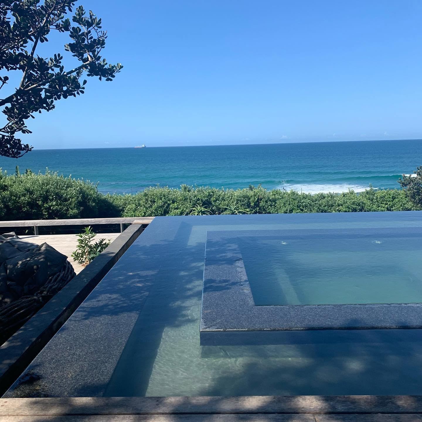 Reflection pool with ocean view at dusk