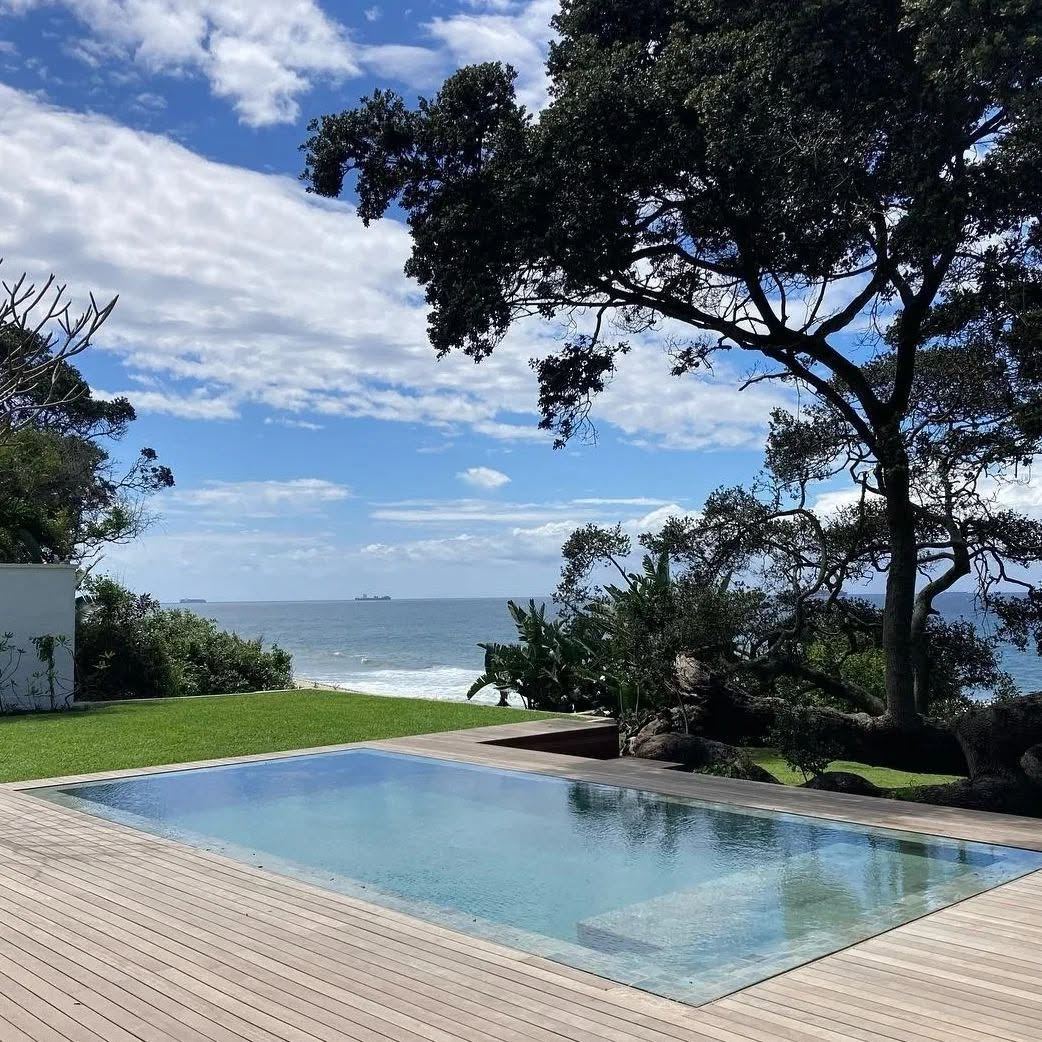 Pool with timber deck framed by trees