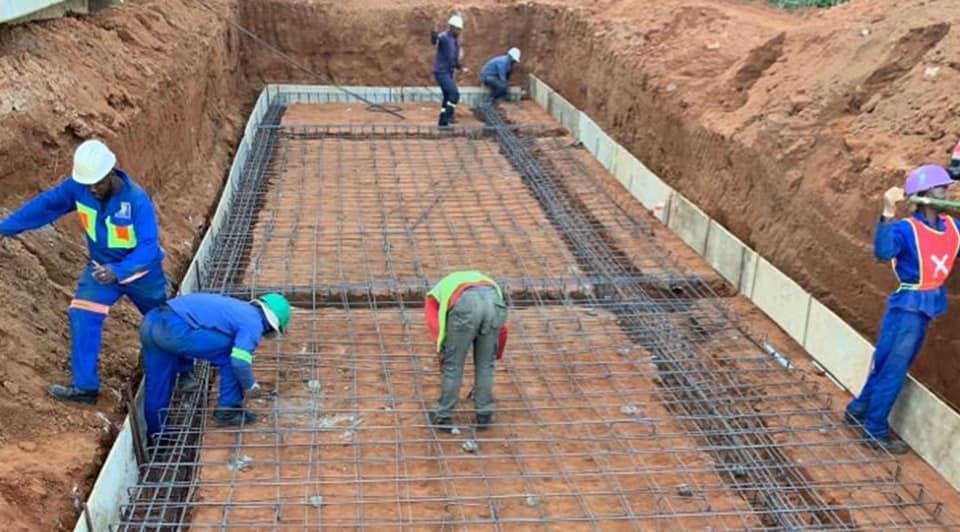 Workers pouring a concrete foundation on a Da Rocca construction site